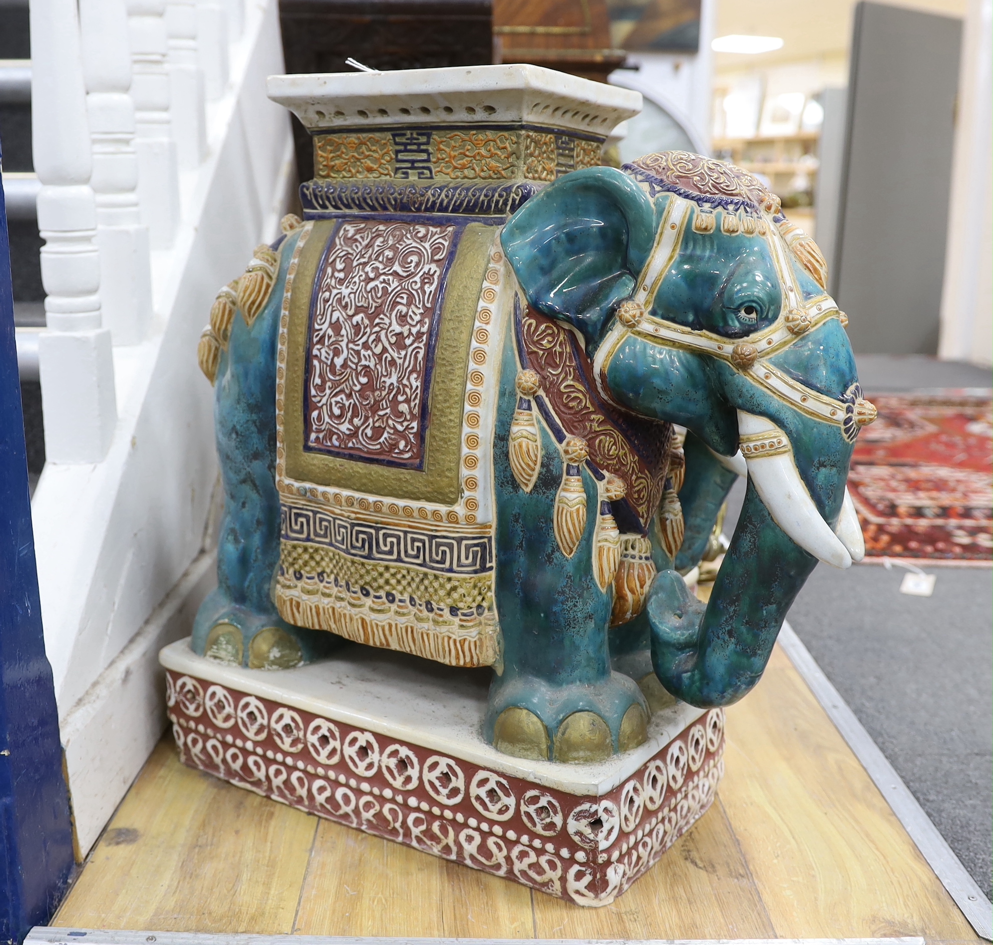A pair of Chinese Guandong pottery ‘elephant and howdah’ stands, 56cm high